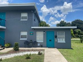 Orlando apartment for rent - a blue house with a blue door and a sidewalk