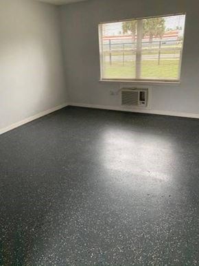 Orlando apartment for rent - an empty room with a window and a black and white floor