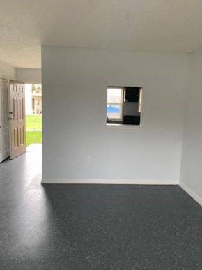 Orlando apartment for rent - an empty living room with a window in the wall