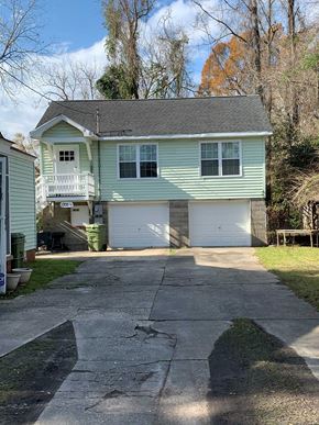 Georgetown apartment for rent - A green house with a white garage door.