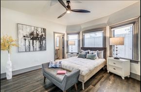 Sacramento apartment for rent - a bedroom with a large bed and a ceiling fan