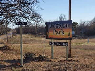 Shawnee house for rent - A sign for Western Park stands in a field with a tree and a smaller sign reading Toby Terra.