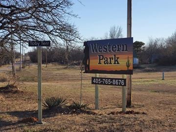 Shawnee house for rent - A sign for Western Park stands in a field with a tree and a smaller sign reading Toby Terra.
