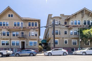 Oakland apartment for rent - Two cars parked in front of a building.