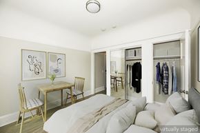 Oakland apartment for rent - A bedroom with a bed, a table and chairs, and a wardrobe.