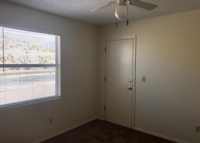 El Paso apartment for rent - A room with a ceiling fan and a window with blinds.