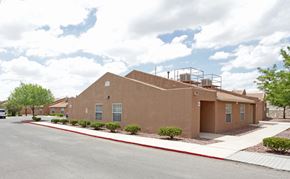 El Paso apartment for rent - A brown building with a red line on the sidewalk.