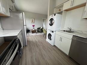 Windsor apartment for rent - A modern kitchen with a washing machine built into the cabinetry.