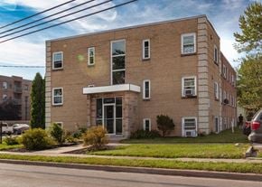 Windsor apartment for rent - A large brick building with a green lawn in front.