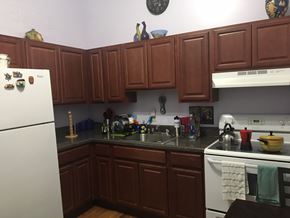 New Haven apartment for rent - a kitchen with brown cabinets and white appliances and a sink