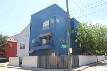 Houston house for rent - a blue building with a fence and a street sign