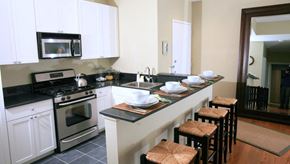 Newark apartment for rent - Newark Apartments-Eleven80 Apartments Kitchen With Split Square Tile And Wood-Style Flooring And Breakfast Bar With Seating