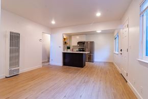 Santa Clara apartment for rent - an empty living room and kitchen with wood floors and a refrigerator