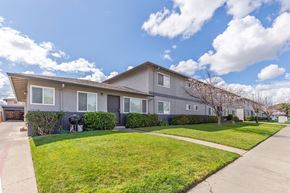 Santa Clara apartment for rent - a house with a lawn and a sidewalk in front of it