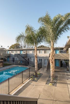 Sunnyvale apartment for rent - a pool and a building with palm trees