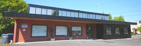 Portland apartment for rent - the front of a brick building with glass windows