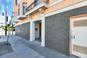 San Francisco apartment for rent - A building with a white door and a black wall.