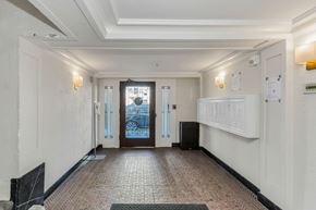 San Francisco apartment for rent - A hallway with a tiled floor and a black speaker on the floor.