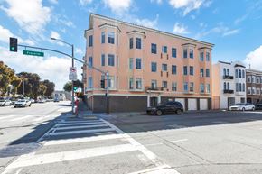 San Francisco apartment for rent - A street view of a crosswalk with a building on the corner.