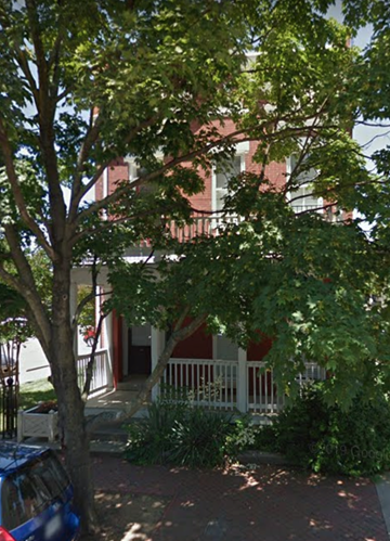 Richmond apartment for rent - A tree in front of a red building.