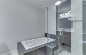 Mauldin house for rent - the master bathroom has a soaking tub and a glass shower