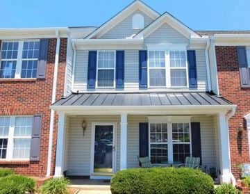 Greer house for rent - A house with a white front porch and black shutters.