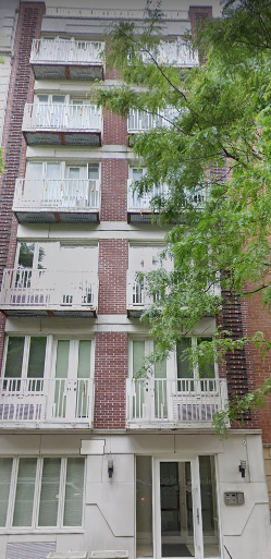 New York apartment for rent - the front of a red brick building with white balconies
