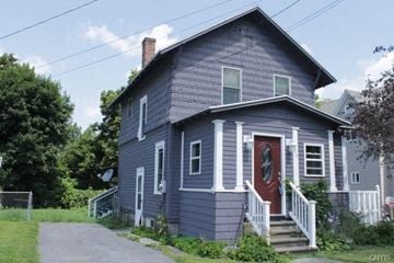 Watertown house for rent - A blue house with a red door and white steps.