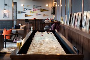 Nashville apartment for rent - A pool table in a room with a couch and a chair.