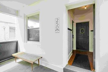 Narberth apartment for rent - the front entrance of a building with a bench and a black door