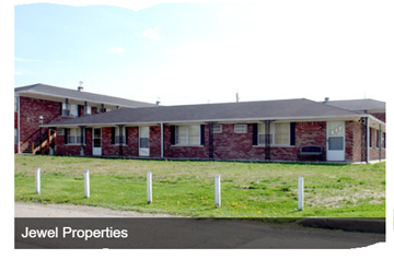 Indianapolis apartment for rent - the front of a brick house with a lawn and a driveway
