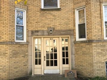 Chicago apartment for rent - the front door of a brick building with two windows