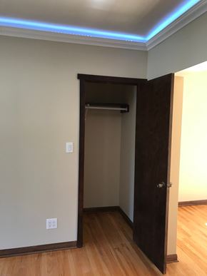 Evanston apartment for rent - A room with a brown door and a light switch on the wall.