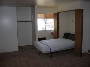 Lodi apartment for rent - a bedroom with a bed and a refrigerator