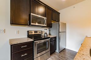 Philadelphia apartment for rent - an updated kitchen with stainless steel appliances and dark wood cabinets