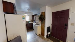 Ann Arbor apartment for rent - a kitchen with white appliances and a brown door