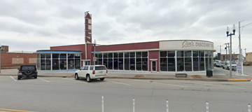 North Kansas City apartment for rent - an old building with a car parked in a parking lot