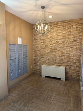 Astoria apartment for rent - A room with a brick wall and a wooden floor.