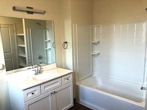 Gilroy apartment for rent - a bathroom with a sink and a tub and a mirror