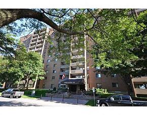 Ottawa apartment for rent - a large building with cars parked in front of it