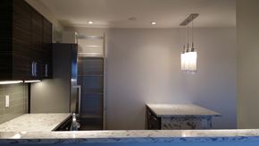 Ottawa apartment for rent - a kitchen with a marble counter top and a stainless steel refrigerator