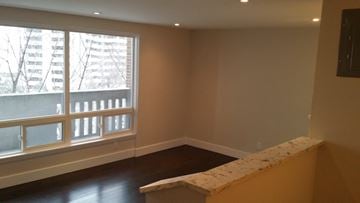 Ottawa apartment for rent - a living room with a large window and a table