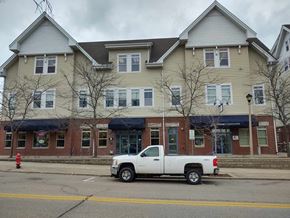 Port Washington apartment for rent - a white truck parked in front of a building