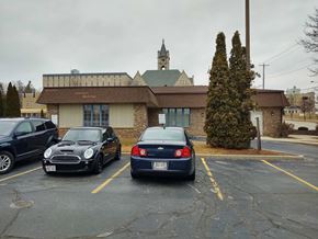Port Washington apartment for rent - a parking lot with three cars in front of a building