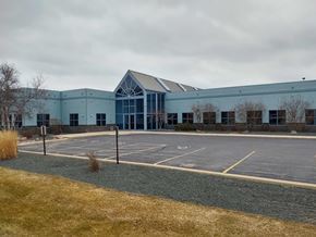 Port Washington apartment for rent - an empty parking lot in front of a blue building
