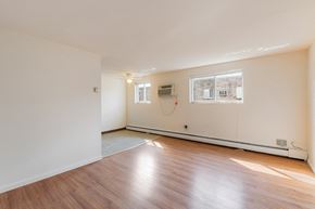 Philadelphia apartment for rent - the living room of an empty house with wood floors and a window