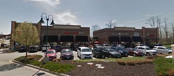 Kansas City apartment for rent - A parking lot in front of a store with cars parked.