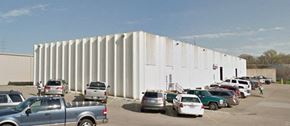 Liberty apartment for rent - a large white building with a parking lot full of cars