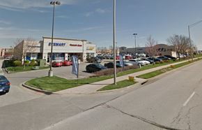 Kansas City apartment for rent - a parking lot with cars parked in front of a store