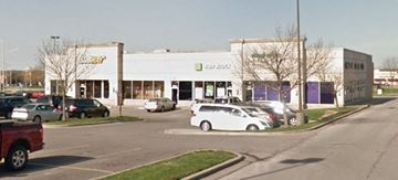 Kansas City apartment for rent - a white building with cars parked in a parking lot